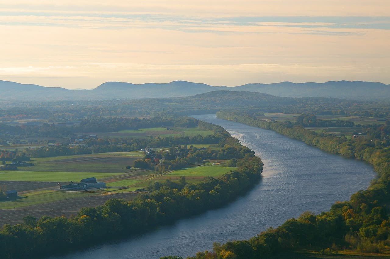 Serene landscape of Sugarloaf Mountain overlooking a river in Connecticut