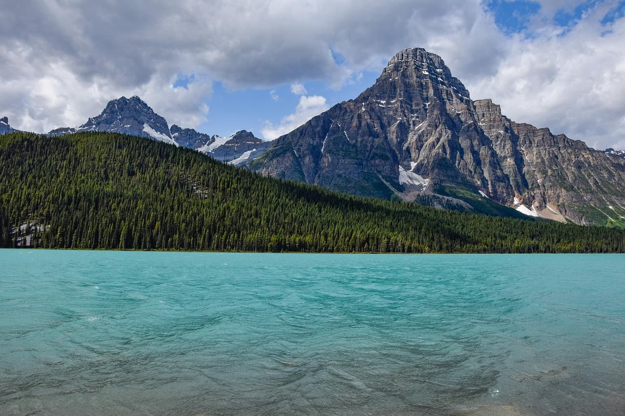 Scenic lake and mountain range in the Rocky Mountains, similar to Montana's national parks