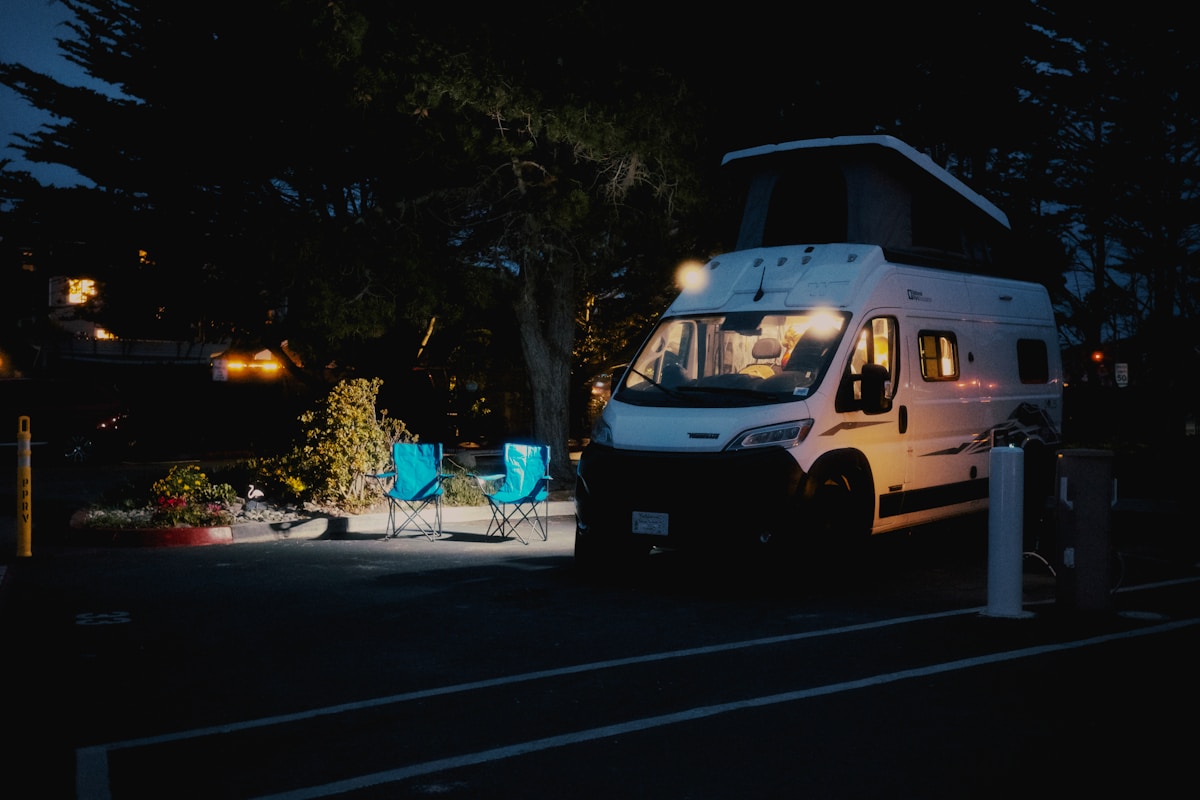 Campervan parked at a campsite at night